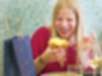woman smiling and just about to take a bite of the panettone cake