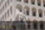 image of a horse and man statue in front of the square colosseum rome's eur district