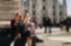 two-women-reading-newspaper-outside-cathrdral-in-milan-italy